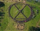 This incredible human sculpture of Extinction Rebellion s logo by the Stone Circle. Greenpeace UK Aerial photo by Andre Pattenden